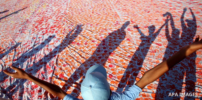 Palestinian children attend an event organised by the the United Nations Relief and Works Agency (UNRWA) in which they attempt to break the Guinness world record for the largest hand-print paint in Khan Yunis, southern G...