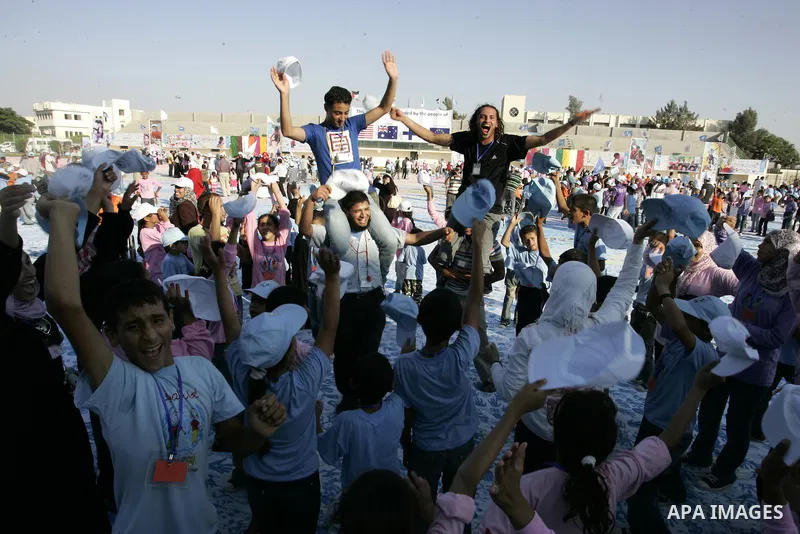 Palestinian children attend an event organised by the the United Nations Relief and Works Agency (UNRWA) in which they attempt to break the Guinness world record for the largest hand-print paint in Khan Yunis, southern G...