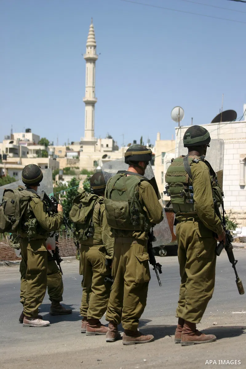 Israeli soldiers take position during a demonstration by Palestinian, Israeli, and foreign protesters in the West Bank village of Beit Omar, near Hebron Friday, July 22, 2011. The demonstration concerned a recent video r...