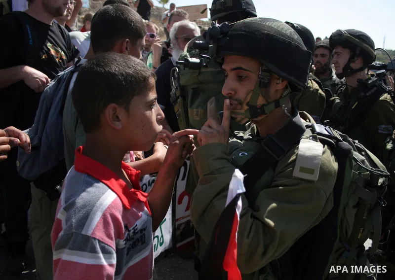 An Israeli soldier scuffles with a protester during a demonstration by Palestinian, Israeli, and foreign protesters in the West Bank village of Beit Omar, near Hebron Friday, July 22, 2011. The demonstration concerned a...