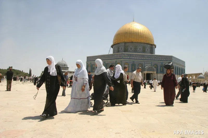 Palestinian Muslim worshippers walk in front of the Dome of the Rock after Friday Prayers at the Al-Aqsa Mosques compound in Jerusalem's Old City on July 22,2011. Photo by Mahfouz Abu Turk