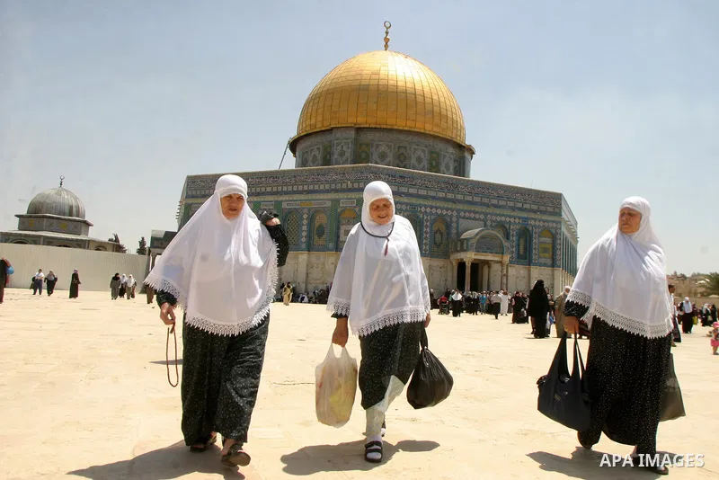 Palestinian Muslim worshippers walk in front of the Dome of the Rock after Friday Prayers at the Al-Aqsa Mosques compound in Jerusalem's Old City on July 22,2011. Photo by Mahfouz Abu Turk