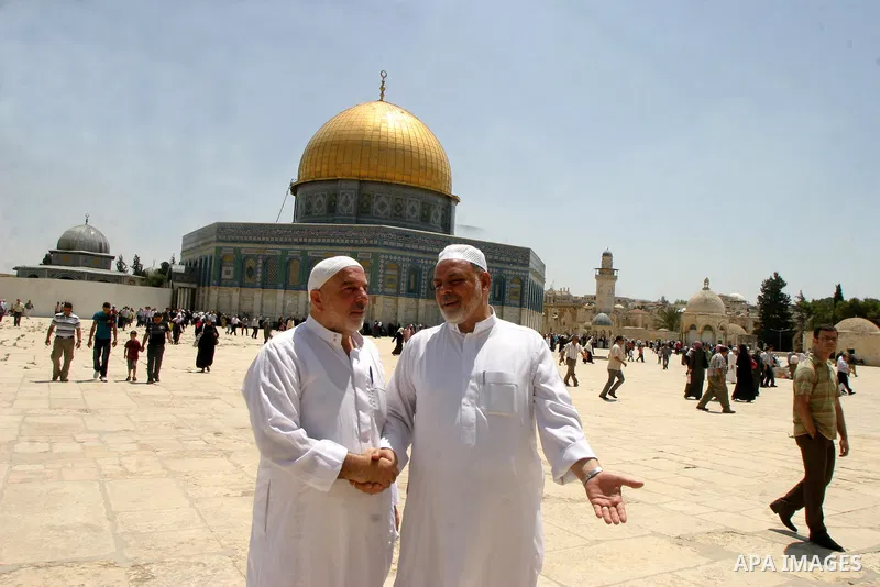 Palestinian Muslim worshippers walk in front of the Dome of the Rock after Friday Prayers at the Al-Aqsa Mosques compound in Jerusalem's Old City on July 22,2011. Photo by Mahfouz Abu Turk