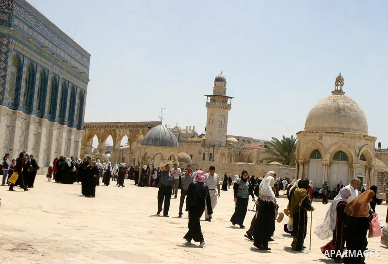 Palestinian Muslim worshippers walk in front of the Dome of the Rock after Friday Prayers at the Al-Aqsa Mosques compound in Jerusalem's Old City on July 22,2011. Photo by Mahfouz Abu Turk