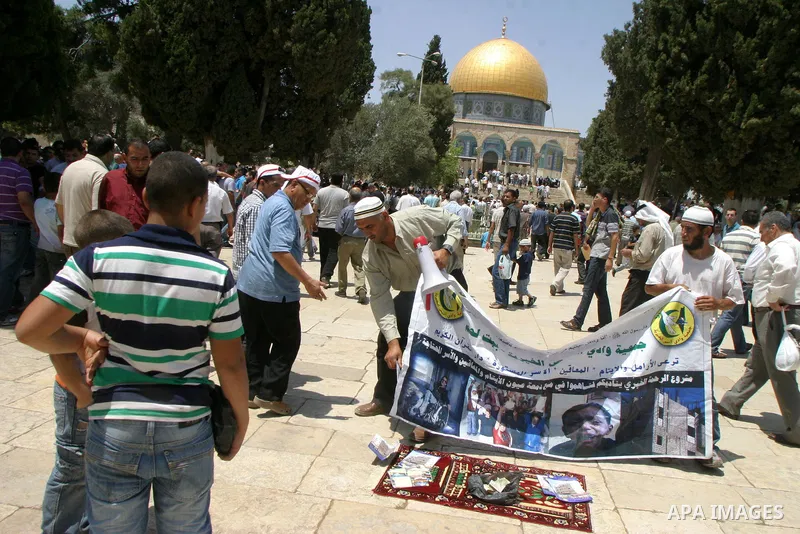 Palestinian Muslim worshippers walk in front of the Dome of the Rock after Friday Prayers at the Al-Aqsa Mosques compound in Jerusalem's Old City on July 22,2011. Photo by Mahfouz Abu Turk