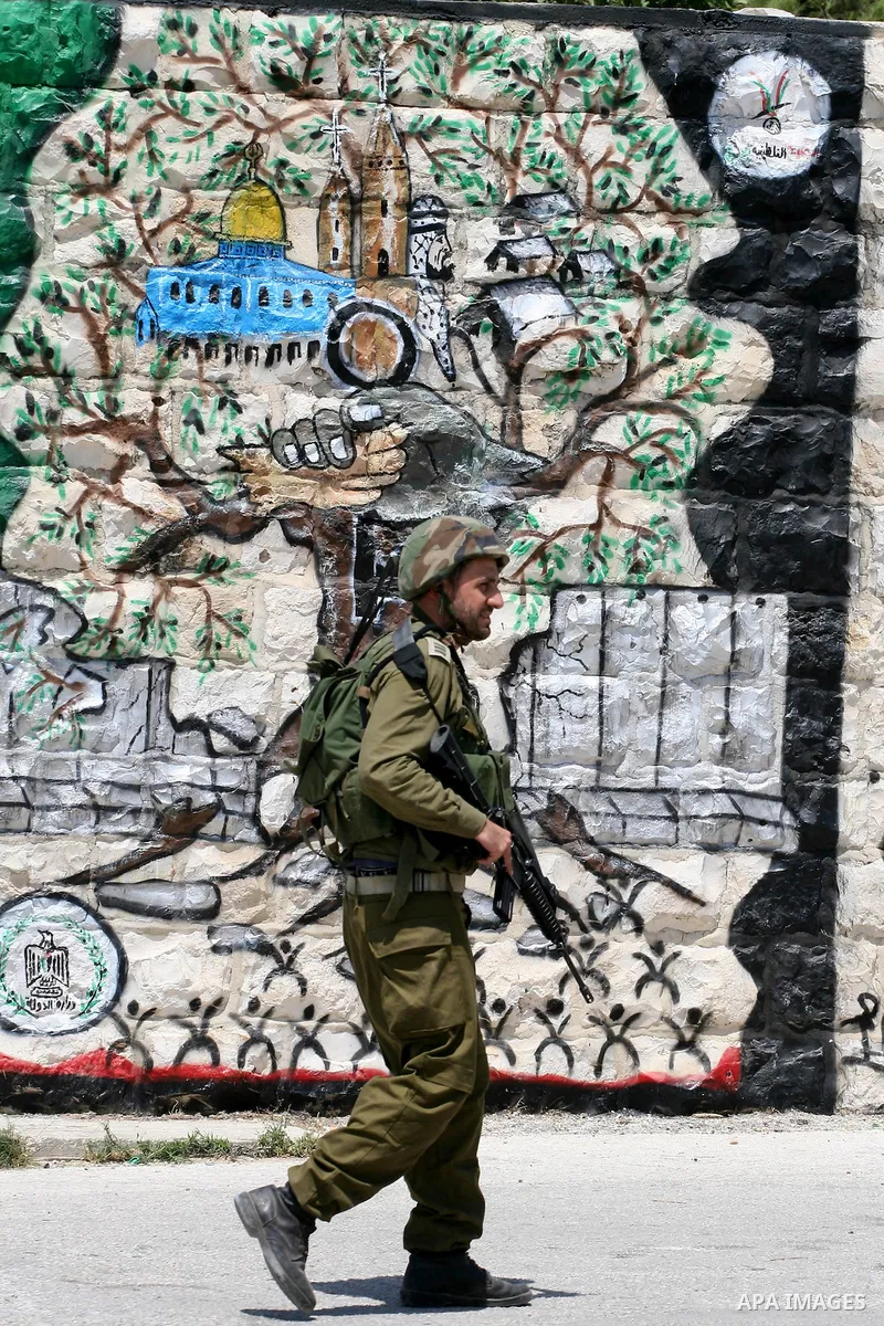 Israeli soldiers take positions during clashes with Palestinian protesters from the West Bank village of Nabi Saleh, north of Ramallah, on July 22, 2011 during a weekly Friday protest against Israeli West Bank settlement...