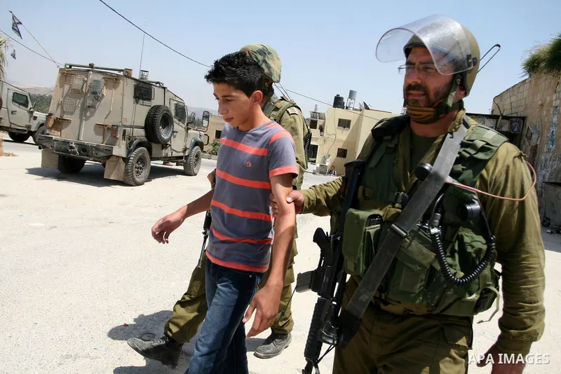 Israeli soldiers detain a protester during clashes with Palestinian protesters from the West Bank village of Nabi Saleh, north of Ramallah, on July 22, 2011 during a weekly Friday protest against Israeli West Bank settle...