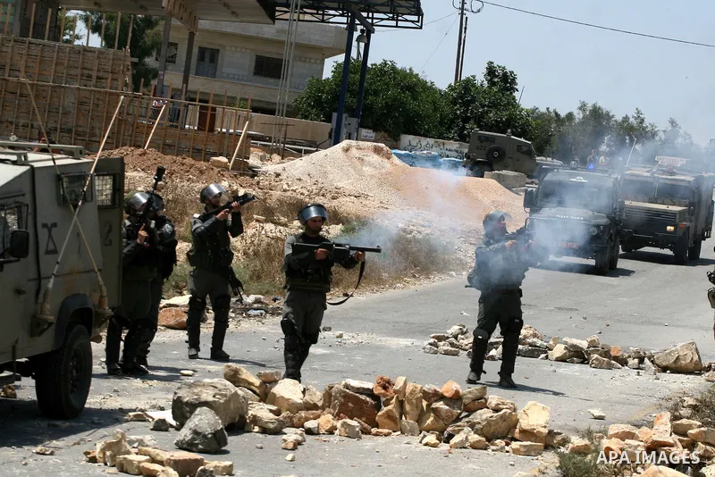 Israeli soldiers fire tear gas grenades during clashes with Palestinian protesters from the West Bank village of Nabi Saleh, north of Ramallah, on July 22, 2011 during a weekly Friday protest against Israeli West Bank se...