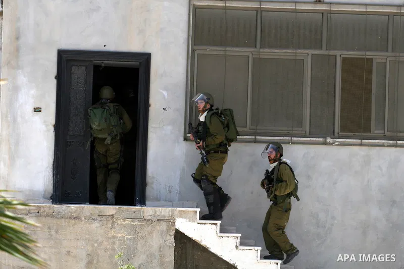 Israeli soldiers take positions during clashes with Palestinian protesters from the West Bank village of Nabi Saleh, north of Ramallah, on July 22, 2011 during a weekly Friday protest against Israeli West Bank settlement...