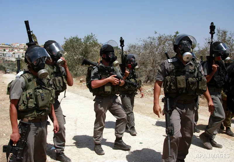 Israeli forces take positions during a demonstration by Palestinian protestors against the closure of a road during the second Intifada by Jewish settlers from the nearby settlement of Kadumim , on July 22, 2011 in the W...