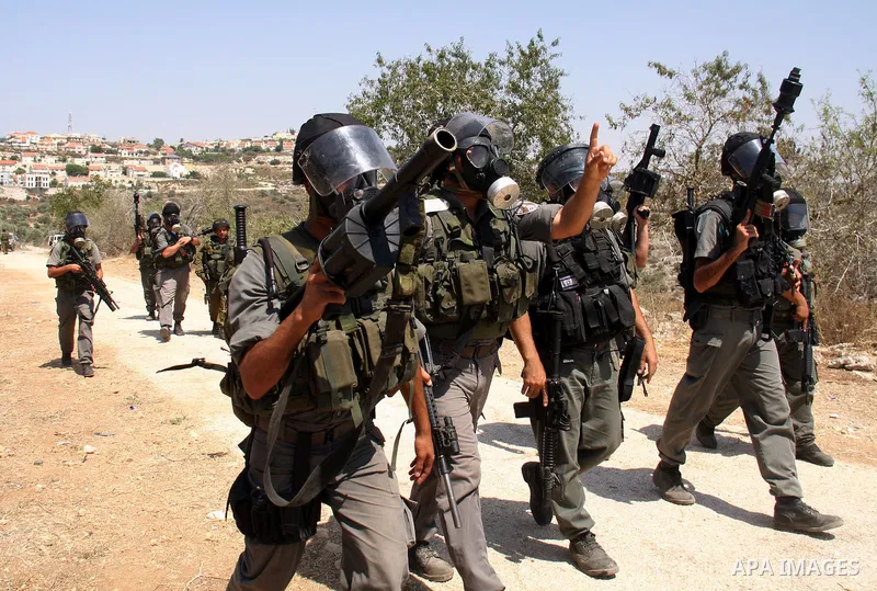 Israeli forces take positions during a demonstration by Palestinian protestors against the closure of a road during the second Intifada by Jewish settlers from the nearby settlement of Kadumim , on July 22, 2011 in the W...