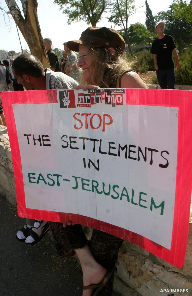 Palestinians, Israelis and foreign activists take part in a weekly demonstration in solidarity with the people of the Sheikh Jarrah neighbourhood who are being expelled from their homes in Jerusalem on July 22,2011. Phot...