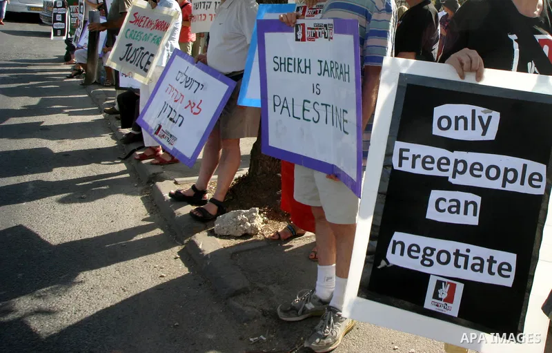Palestinians, Israelis and foreign activists take part in a weekly demonstration in solidarity with the people of the Sheikh Jarrah neighbourhood who are being expelled from their homes in Jerusalem on July 22,2011. Phot...