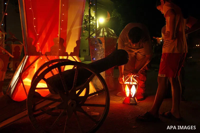 Palestinian children gather around a giant paper lantern, traditionally used as decoration during the Muslim holy month of Ramadan, in Gaza City on July 23, 2011. Photo by Mahmud Nassar