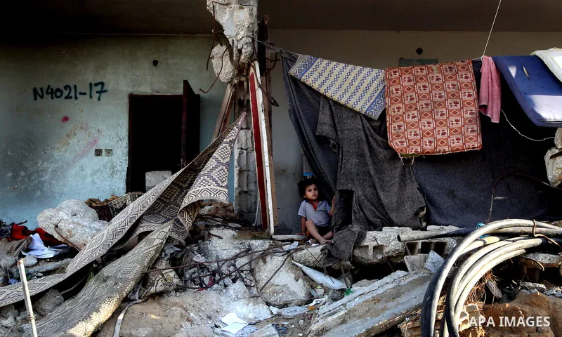 A Palestinian child plays inside her family destroyed house in Jabaliya refugee camp, in the northern Gaza Strip on 23 July 2011 house was destroyed during the Israeli assault on Gaza in late 2008 to early 2009, and beca...