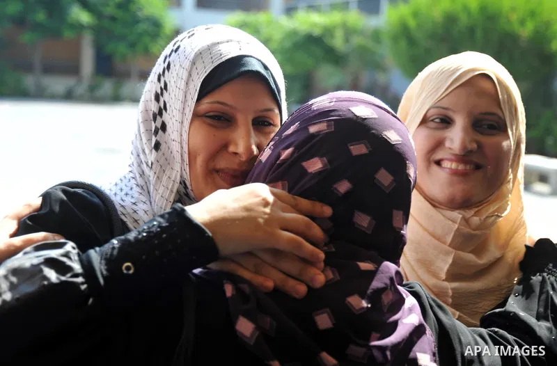 Palestinian relatives Hug their secondary school students after find their results in Gaza city on July 24,2011. The Ministry of Education in Gaza Strip and the West Bank announced the results together. Photo by Majdi Fa...