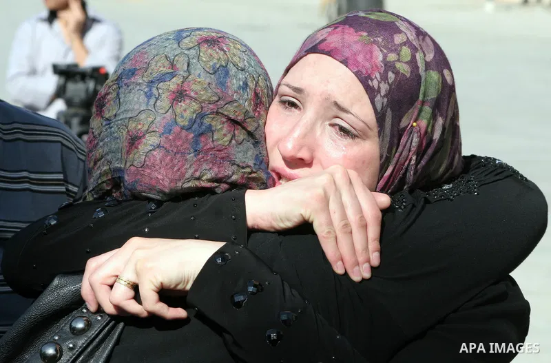 Palestinian relatives Hug their secondary school students after find their results in the West Bank city of Hebron on July 24, 2011.Photo by Najeh Hashlamoun