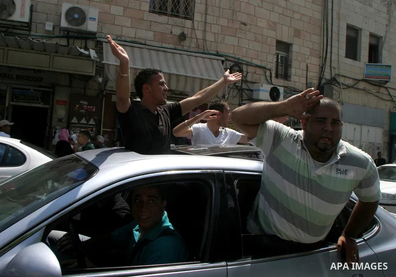 Palestinian students celebrate after they received their results of final high school exams, known as "Tawjihi" in Jerusalem's old city on July 24,2011.. Photo by Mahfouz Abu Turk