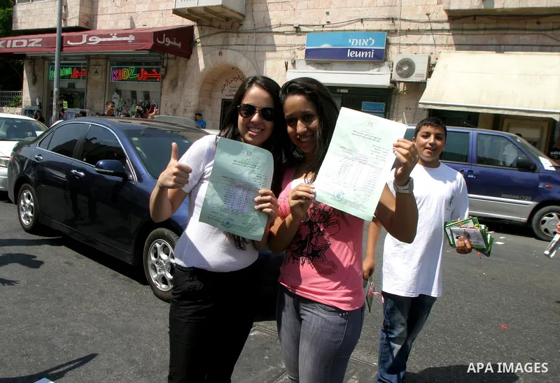 Palestinian students celebrate after they received their results of final high school exams, known as "Tawjihi" in Jerusalem's old city on July 24,2011.. Photo by Mahfouz Abu Turk