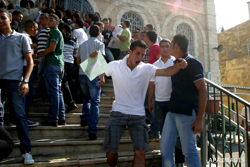 Palestinian students celebrate after they received their results of final high school exams, known as "Tawjihi" in Jerusalem's old city on July 24,2011.. Photo by Mahfouz Abu Turk