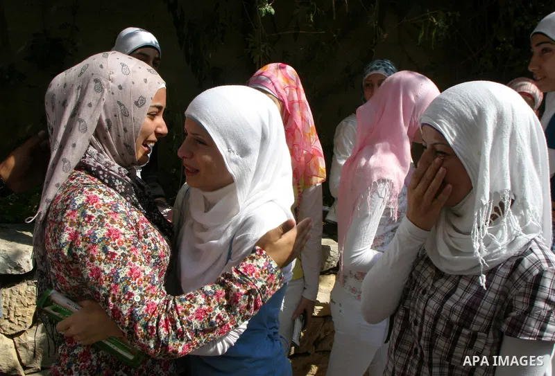 Palestinian students celebrate after they received their results of final high school exams, known as "Tawjihi" in Jerusalem's old city on July 24,2011.. Photo by Mahfouz Abu Turk