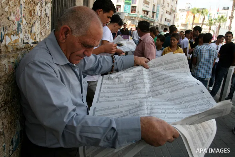 Palestinians look for their relatives' names in the results of final high school exams, known as "Tawjihi" in the West Bank city of Ramallah on July 24,2011. Photo by Issam Rimawi