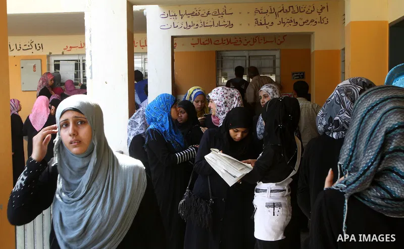 Palestinian secondary school students read a local newspaper to find their results in Gaza city on July 24,2011. The Ministry of Education in Gaza Strip and the West Bank announced the results together. Photo by Ashraf a...