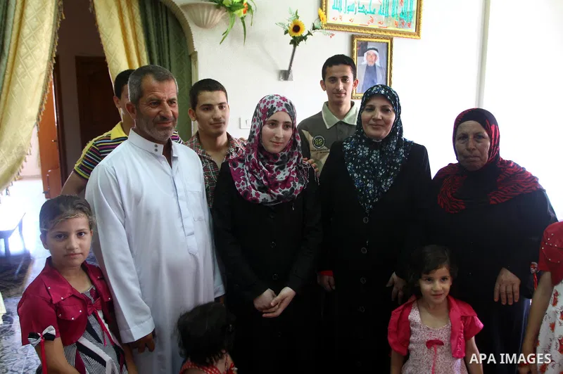 A Palestinian secondary school student and the tenth in section literary, Majd Daher celebrates with her family after received her result in Gaza city on July 24,2011. The Ministry of Education in Gaza Strip and the West...