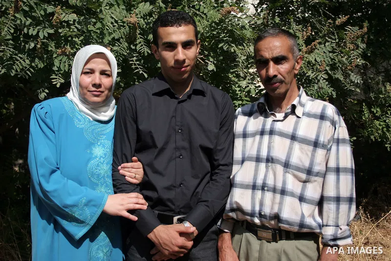 A Palestinian student from the top ten in the general secondary certificate in Palestine, Mohammed Jafar Karki with average of 99.5 % , is greeted by his family in the West Bank city of Hebron , Sunday, July 24, 2011. Ph...