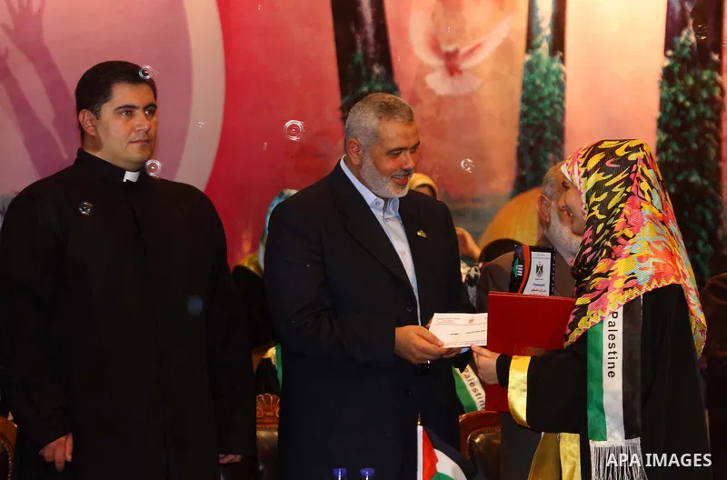 Palestinian Prime Minister in Gaza Strip, Ismail Haniya participates in a celebration in Gaza city on July 24,2011 to honor the students who gained the highest marks in the final high school exams, known as "Tawjihi" at...