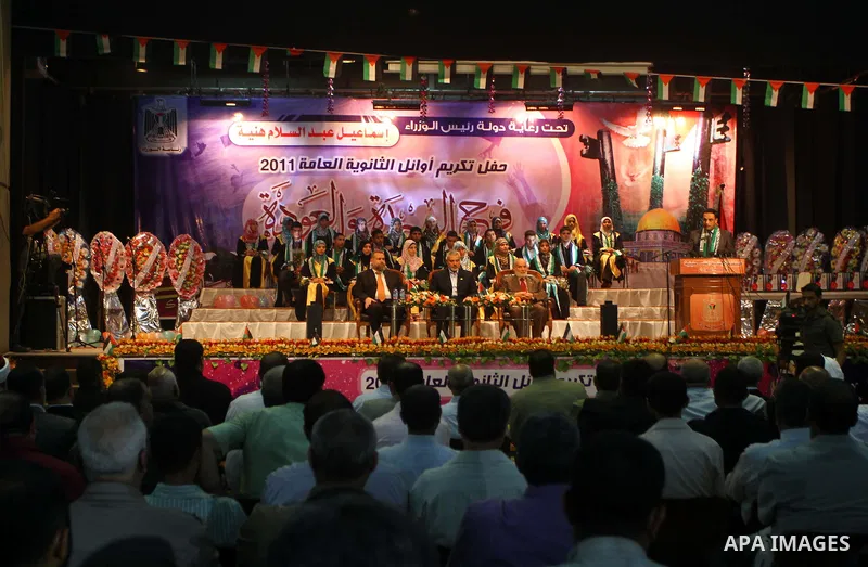Palestinian Prime Minister in Gaza Strip, Ismail Haniya participates in a celebration in Gaza city on July 24,2011 to honor the students who gained the highest marks in the final high school exams, known as "Tawjihi" at...