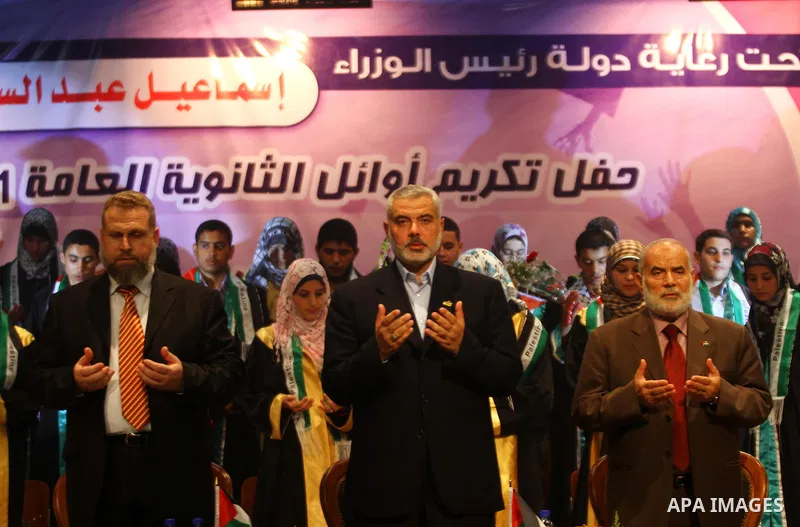 Palestinian Prime Minister in Gaza Strip, Ismail Haniya participates in a celebration in Gaza city on July 24,2011 to honor the students who gained the highest marks in the final high school exams, known as "Tawjihi" at...