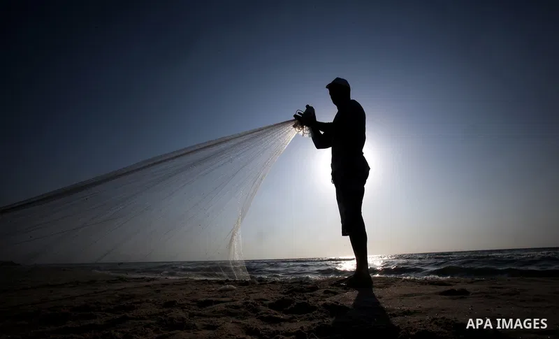 A Palestinian fisherman prepares his nets for fishing at Shatie refugee camp beach, western Gaza city, 24 July 2011. The UN Relief and Works Agency (UNRWA) will reduce some of its services for Palestinian refugees due to...