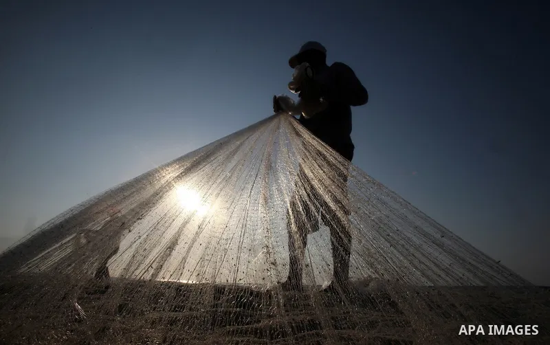 A Palestinian fisherman prepares his nets for fishing at Shatie refugee camp beach, western Gaza city, 24 July 2011. The UN Relief and Works Agency (UNRWA) will reduce some of its services for Palestinian refugees due to...