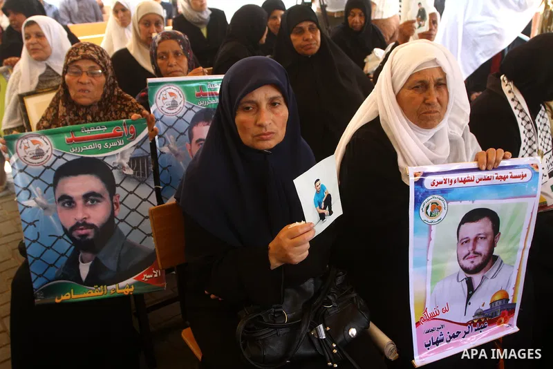 Palestinians women hold pictures of their prisoned relatives in Israeli jails as they gather in a weekly activity calling for their liberty at the Red Cross headquarters in Gaza City on July 25, 2011. About 7000 prisoner...