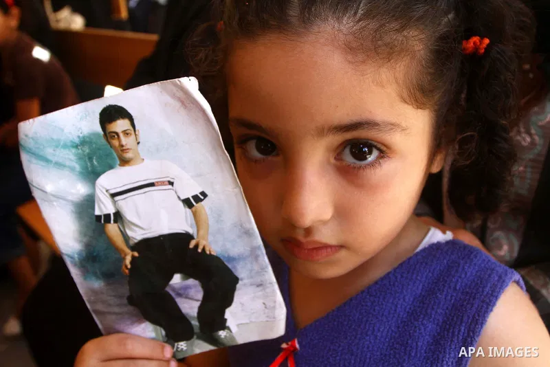 Palestinians women hold pictures of their prisoned relatives in Israeli jails as they gather in a weekly activity calling for their liberty at the Red Cross headquarters in Gaza City on July 25, 2011. About 7000 prisoner...
