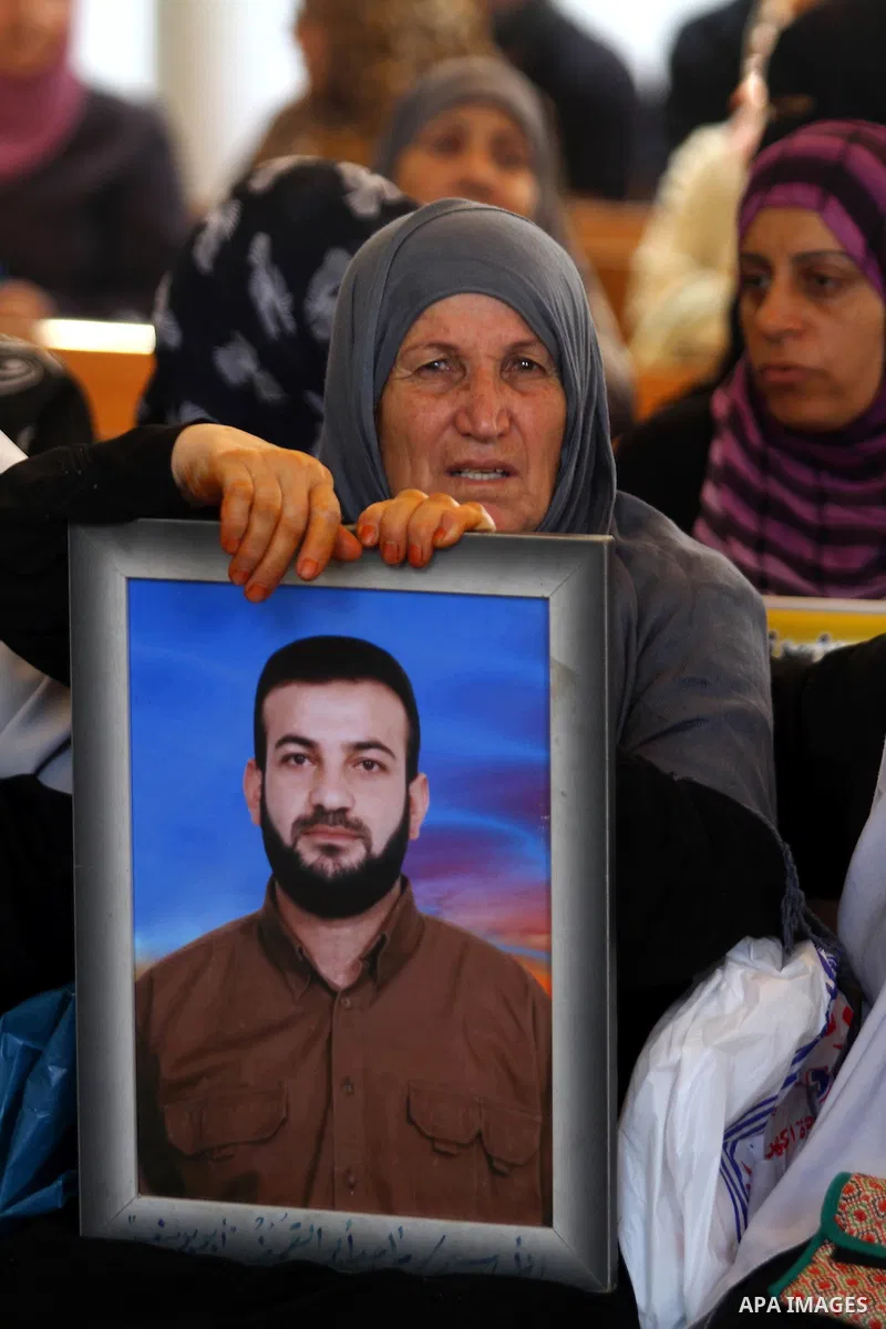 Palestinians women hold pictures of their prisoned relatives in Israeli jails as they gather in a weekly activity calling for their liberty at the Red Cross headquarters in Gaza City on July 25, 2011. About 7000 prisoner...