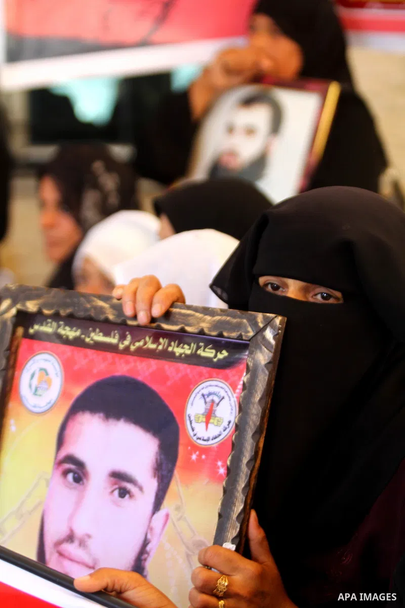 Palestinians women hold pictures of their prisoned relatives in Israeli jails as they gather in a weekly activity calling for their liberty at the Red Cross headquarters in Gaza City on July 25, 2011. About 7000 prisoner...
