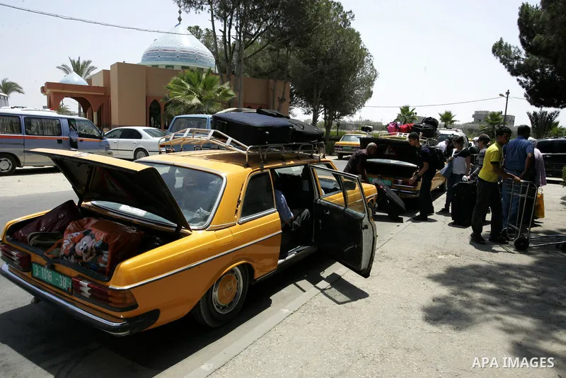 Palestinians sit in a car as they wait to cross into Egypt through the Rafah border crossing in the southern Gaza Strip on on July 25, 2011. Photo by Abed Rahim Khatib