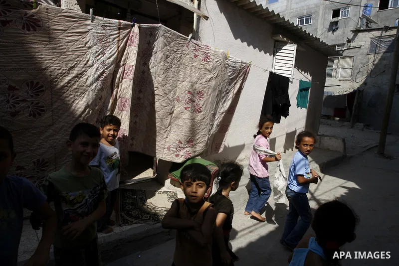 Palestinian children play in front of their house Al Shate` refugee camp in the west of Gaza City on July 25, 2011. Photo by Mahmud Nassar