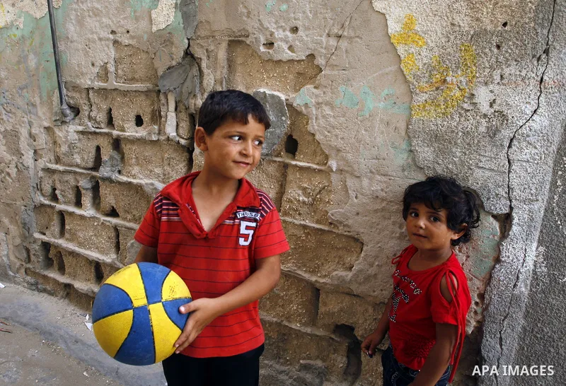 Palestinian boys play football in front of their house Al Shate` refugee camp in the west of Gaza City on July 25, 2011. Photo by Mahmud Nassar