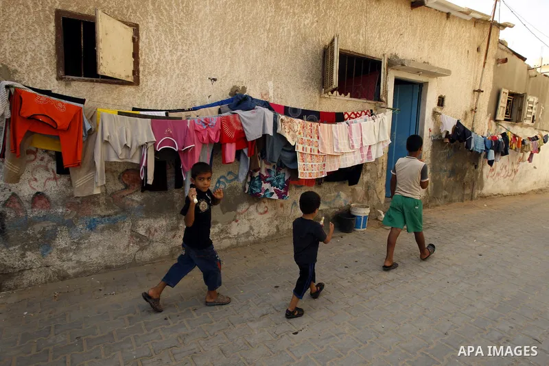 Palestinian children play in front of their house Al Shate` refugee camp in the west of Gaza City on July 25, 2011. Photo by Mahmud Nassar