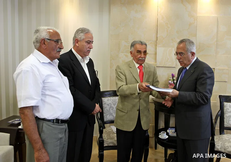 Palestinian Prime Minister, Salam Fayyad receives a report of the fact-finding in the case of bread in the West Bank city of Ramallah on July 25, 2011. Photo by Mustafa Abu Dayeh