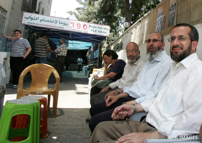 Palestinian Hamas legislators Ahmed Atun, Mohammed Totah and Khaled Abu Arafa receive Palestinian supporters at the Red Cross compound in east Jerusalem on July 26, 2011. The Hamas MPs live inside the compound for the pa...