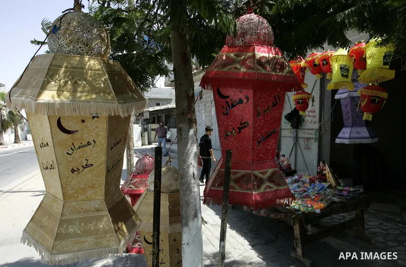 A Palestinian vendor displays a giant lanterns, traditionally used as decoration during the Muslim holy month of Ramadan at a shop in Rafah, southern Gaza Strip on July 26, 2011. The start of Ramadan in the ninth of the...