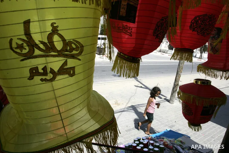 A Palestinian vendor displays a giant lanterns, traditionally used as decoration during the Muslim holy month of Ramadan at a shop in Rafah, southern Gaza Strip on July 26, 2011. The start of Ramadan in the ninth of the...