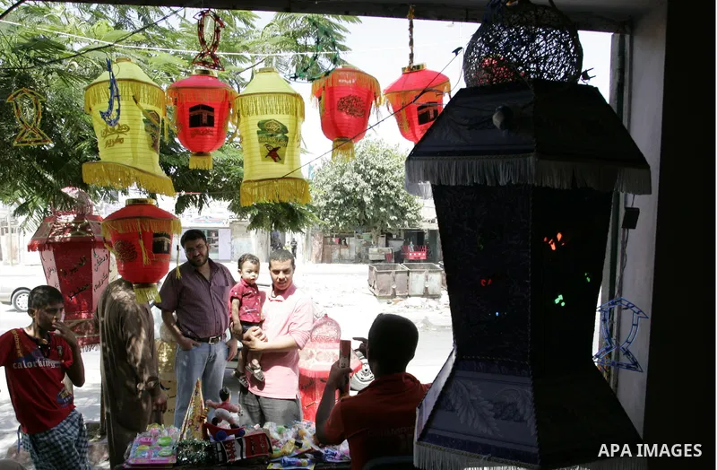 A Palestinian vendor displays a giant lanterns, traditionally used as decoration during the Muslim holy month of Ramadan at a shop in Rafah, southern Gaza Strip on July 26, 2011. The start of Ramadan in the ninth of the...