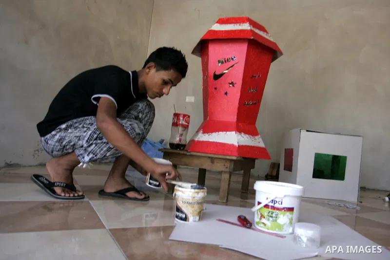A Palestinian boy makes a giant lanterns, traditionally used as decoration during the Muslim holy month of Ramadan at a shop in Rafah, southern Gaza Strip on July 26, 2011. The start of Ramadan in the ninth of the Muslim...