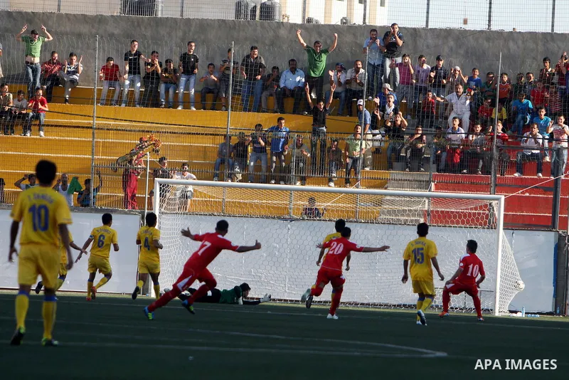 Palestinian's team and Thailand's team fight for the ball during their 2014 FIFA World Cup qualification soccer match at A-Ram stadium near Jerusalem July 28, 2011. Photo by Issam Rimawi