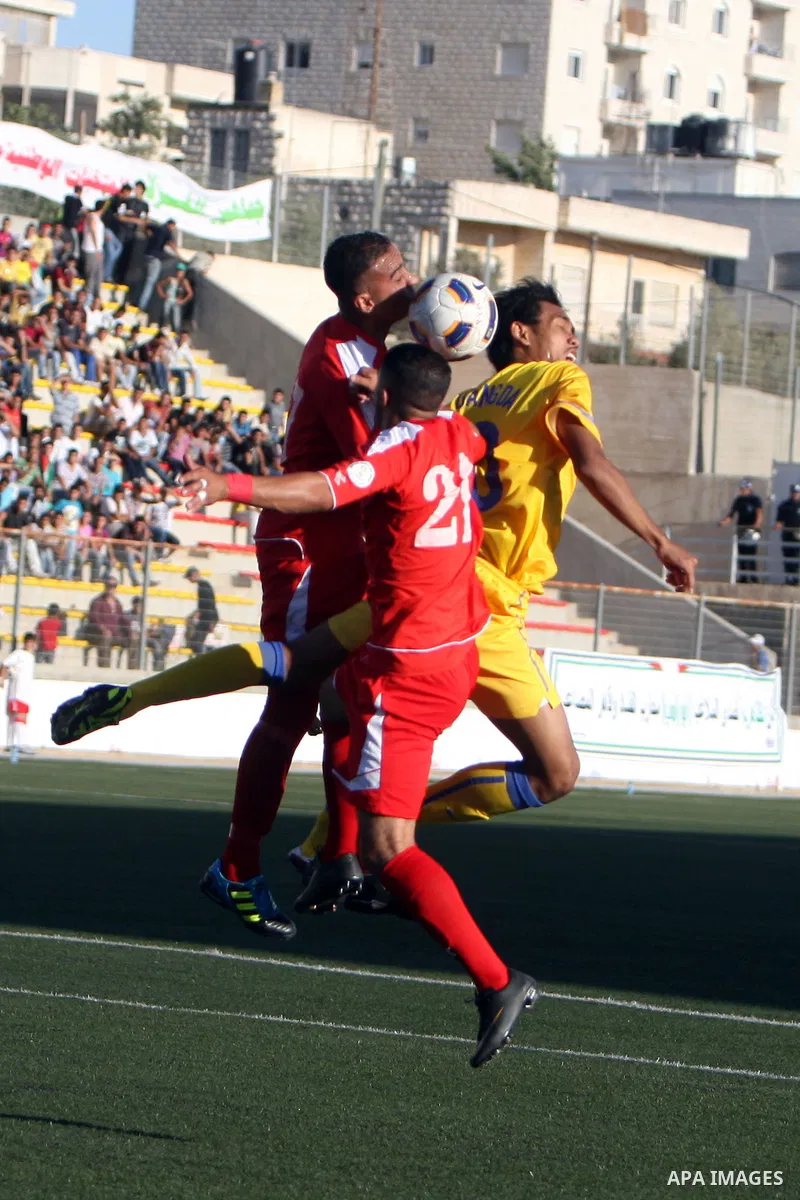 Palestinian's team and Thailand's team fight for the ball during their 2014 FIFA World Cup qualification soccer match at A-Ram stadium near Jerusalem July 28, 2011. Photo by Issam Rimawi